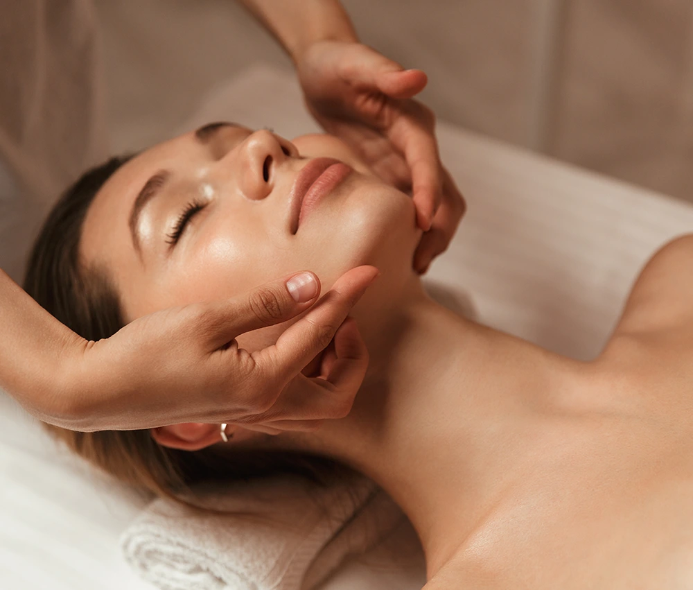 Woman enjoying an aesthetician-administered acne facial treatment in Brea, CA