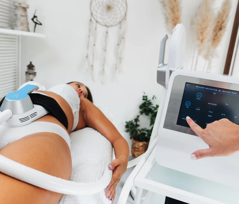Client lying comfortably while receiving non-invasive body sculpting and contouring