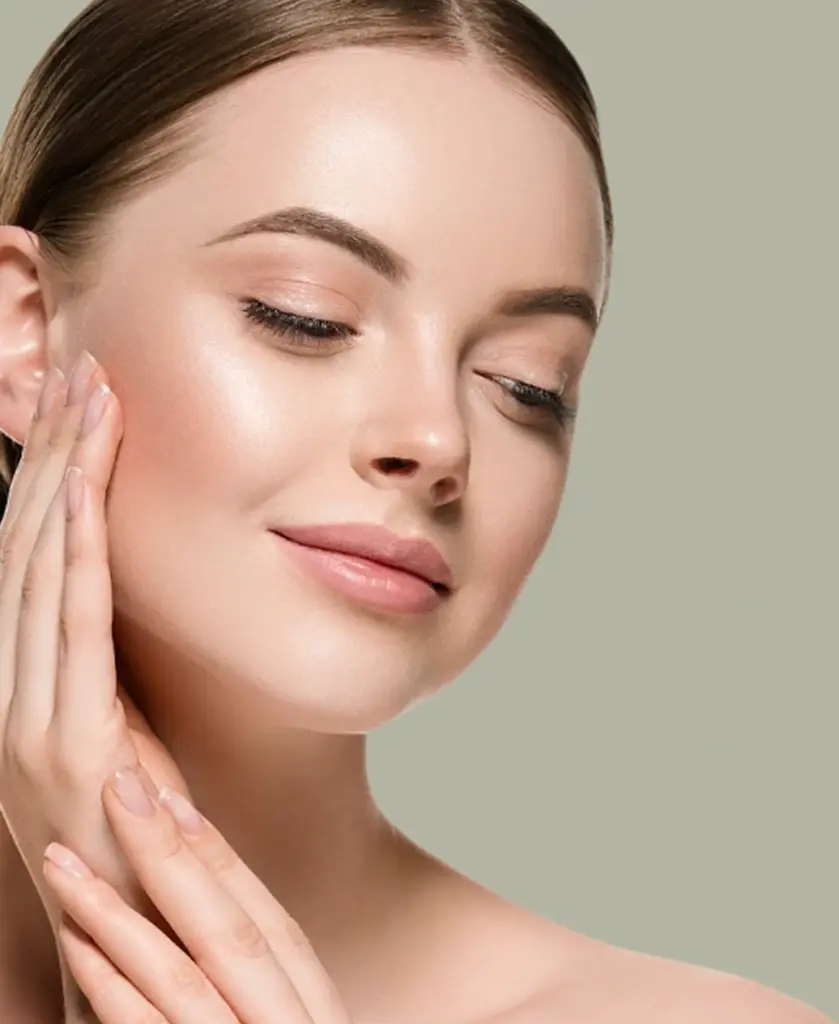 Close-up of a woman's glowing face demonstrating natural dermal filler results in Brea, California
