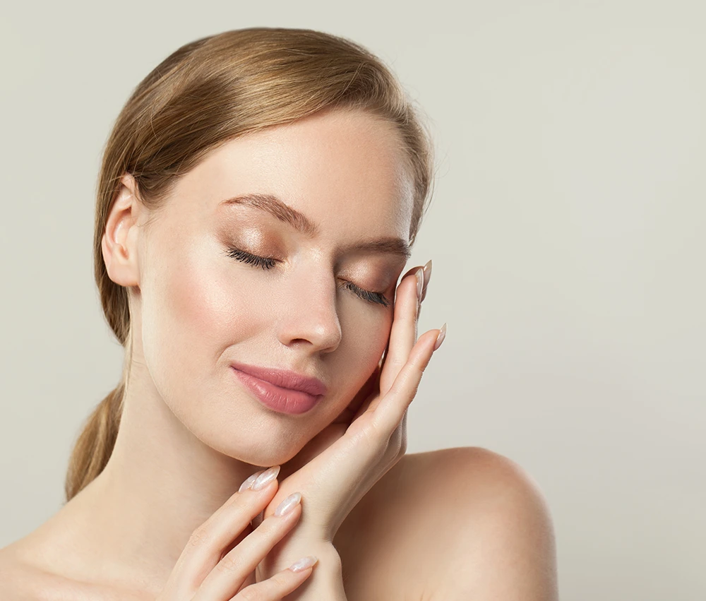 "Woman with clear complexion showing skin rejuvenation results from exosome skin booster treatment