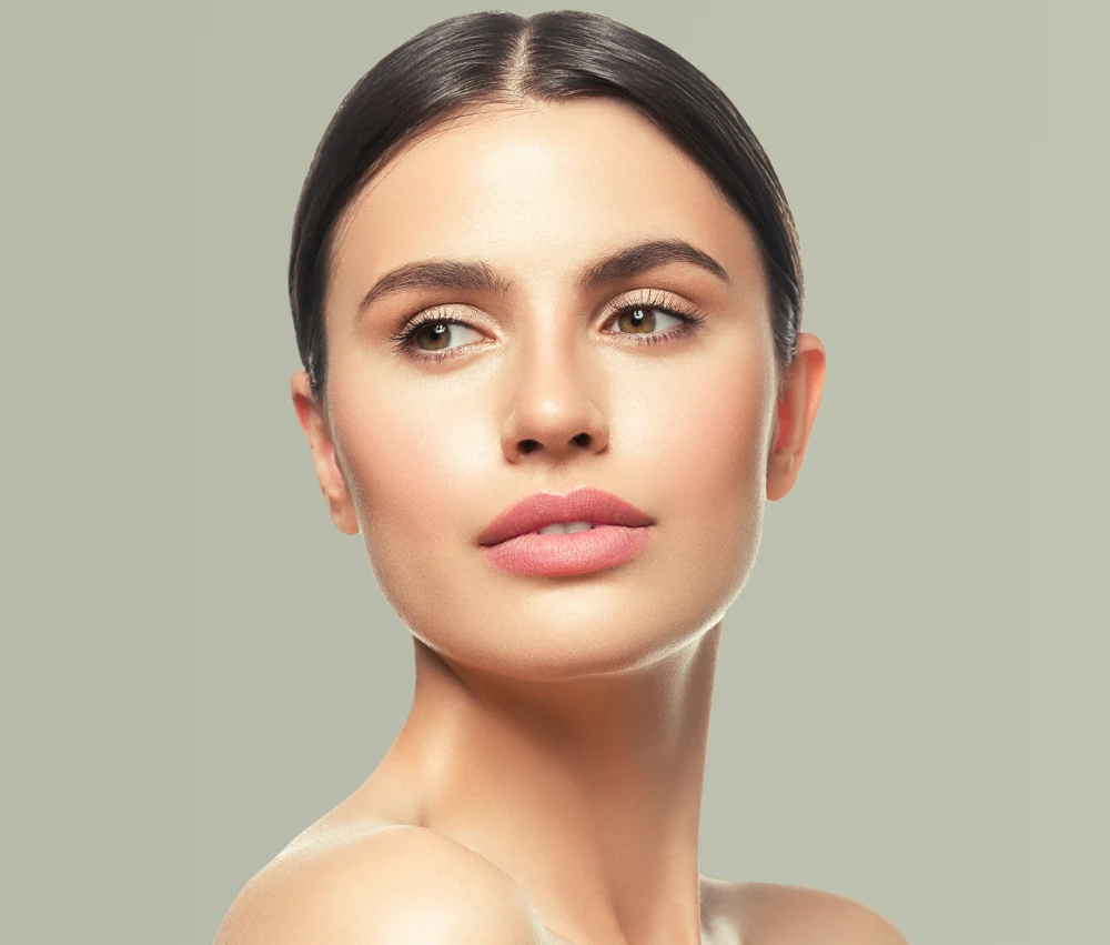 Frontal view of a woman with sleek dark hair showing firm, glowing skin post-InMode Forma
