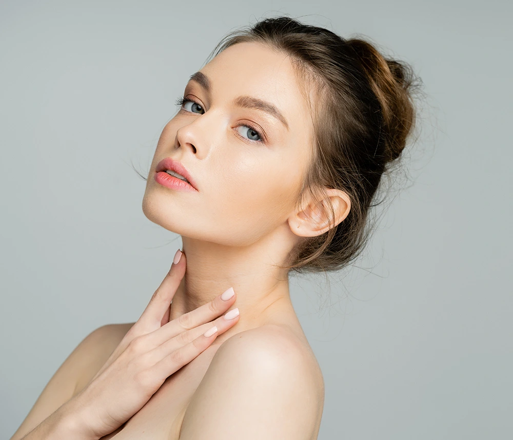 Woman tilting her head back to highlight defined jawline and chin volume after JuveLook treatment