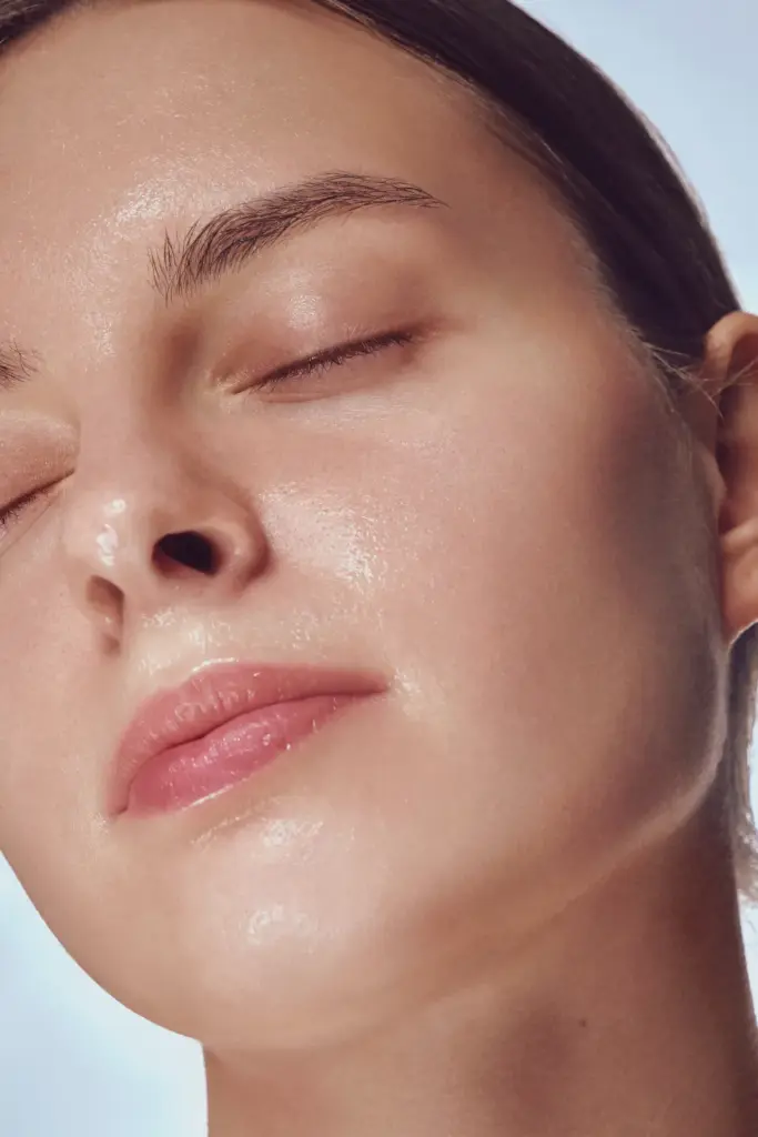 Client lying down with eyes closed while receiving an infusion during an Oxygen Facial