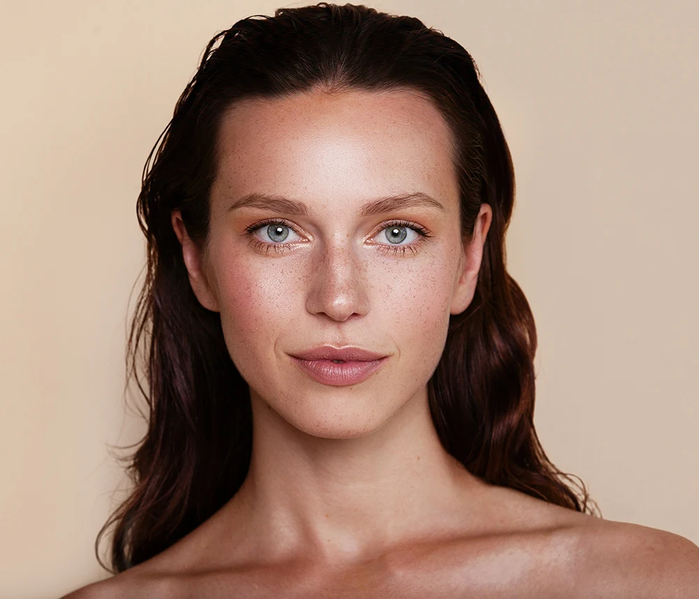 Portrait of a brunette woman with smooth skin texture and even skin tone post PRF EZ Gel treatment.
