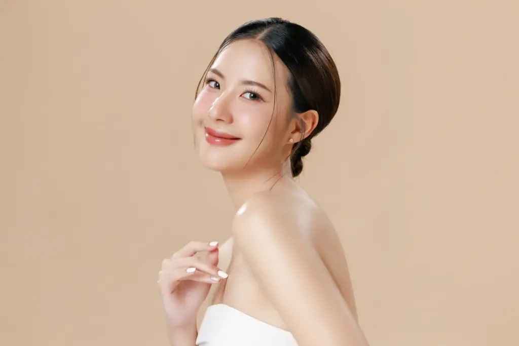 Smiling woman with radiant skin showcasing natural rejuvenation after Re2O skin booster treatment.
