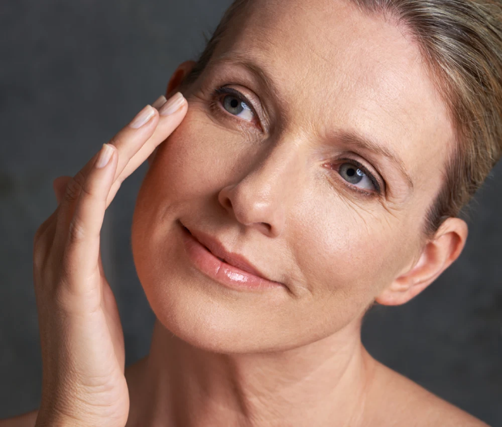 Close-up of a woman touching her cheek to highlight firm skin from Trifill Pro Plus treatment