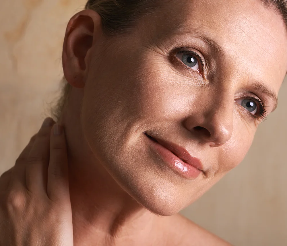 Close-up profile of a mature woman showing radiant, firm cheek skin after Ultracol treatment